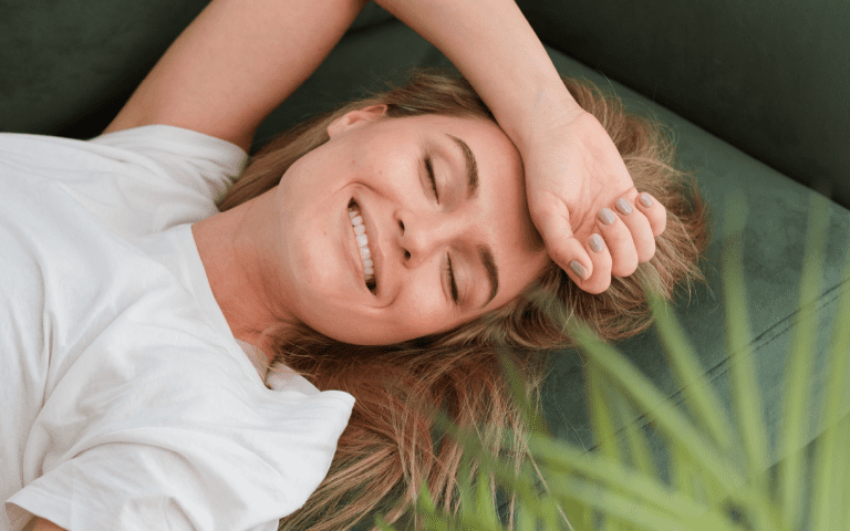 woman lying on a bed of grass