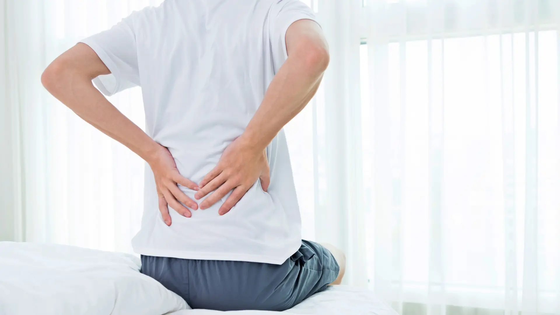 Man with back pain in bed