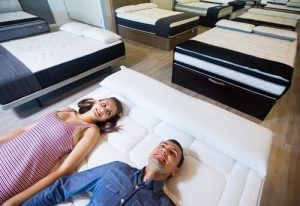 Couple testing a new mattress in store