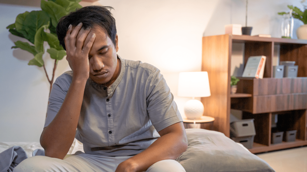 Man struggling to stay asleep
