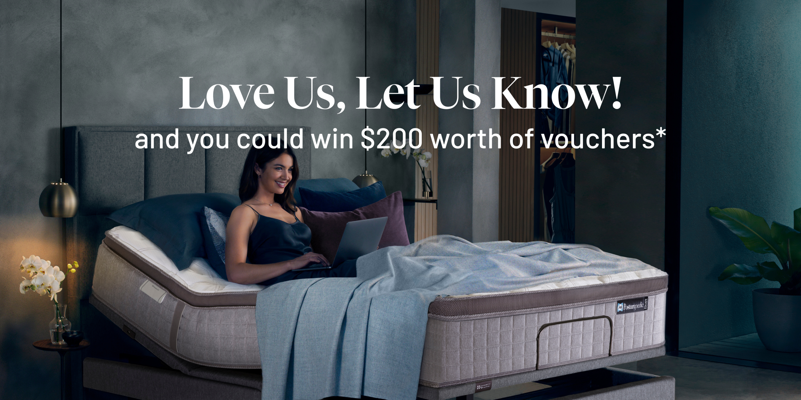 A women using her laptop on a sealy mattress. Includes text overlay that states Love us, let us know!