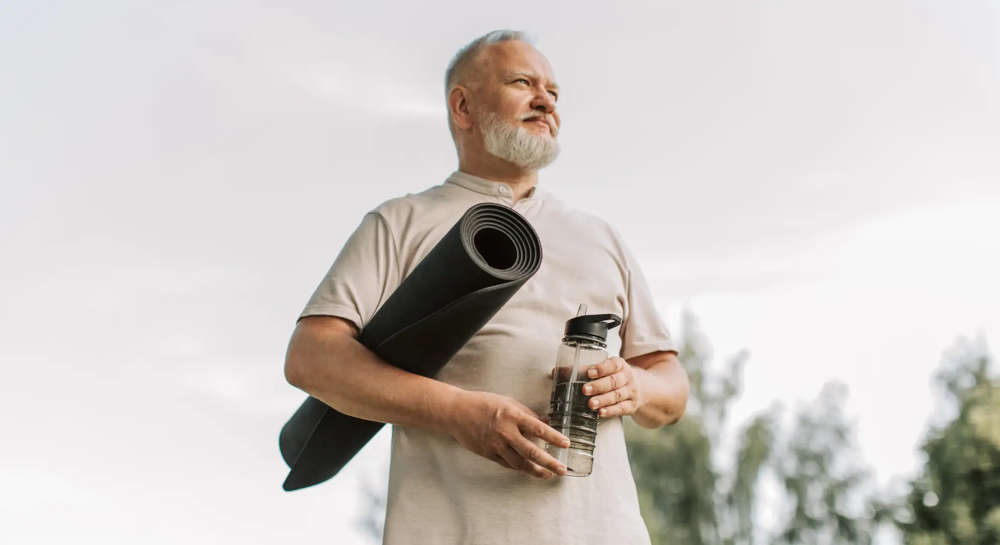 Man holding yoga mat for stretching