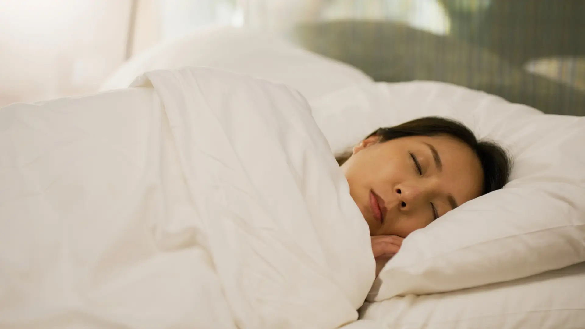 Woman asleep under duvet