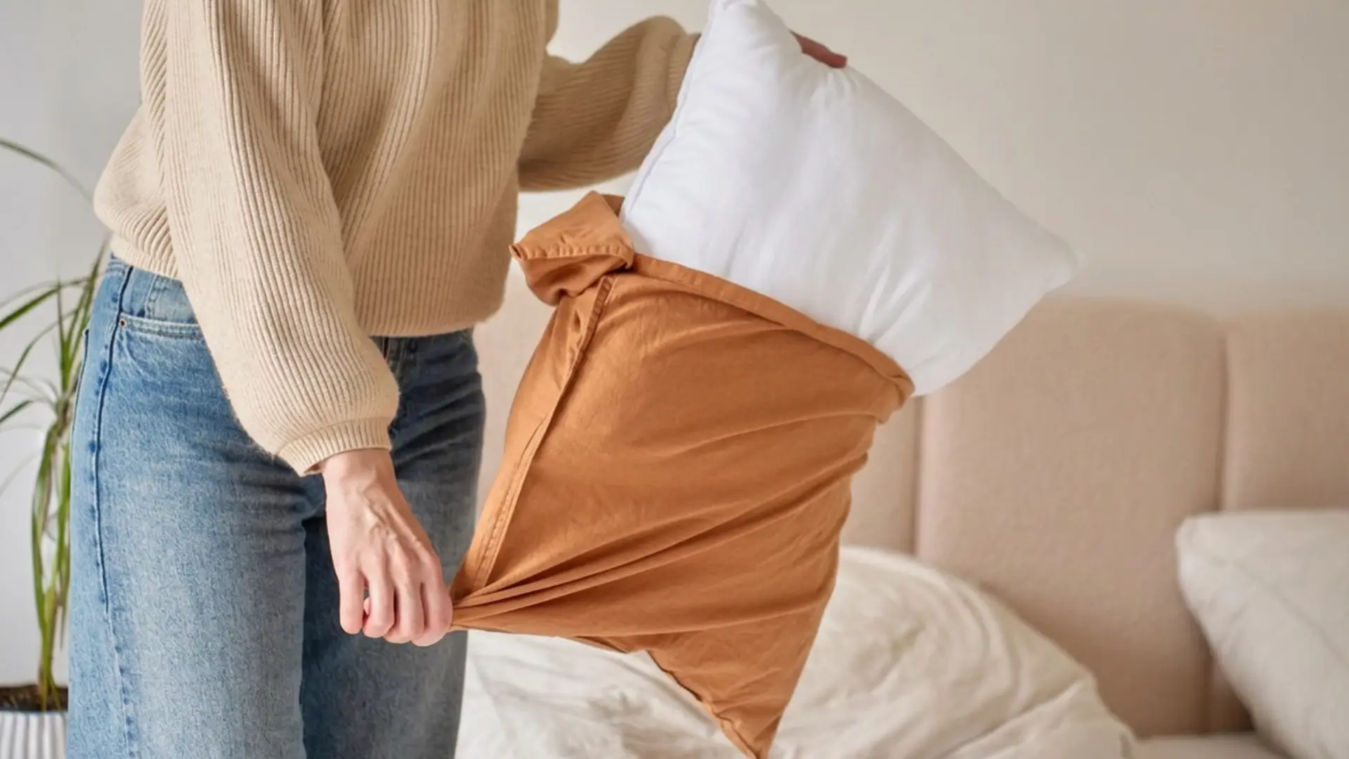 Woman putting on pillowcase