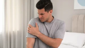 Man with sore shoulder in bed