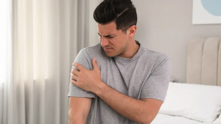 Man with sore shoulder in bed
