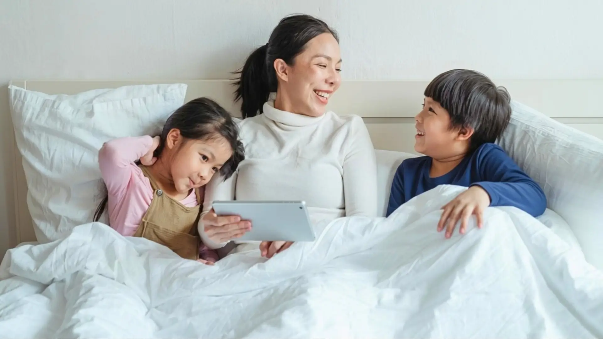 Mother in bed with kids